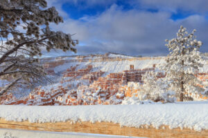 A split rail fence frames an otherwise magical snow storm in Bryce Canyon