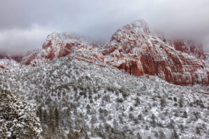 Clouds begin rolling out of Kolob Canyon in Zion National Park, revealing a winter wonderland of snow and ice.