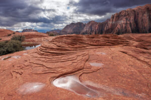 A winter storm begins clearing from Snow Canyon State Park in St George Utah. Prehistoric sand dunes conjure up images of dinosaurs in this land before time.