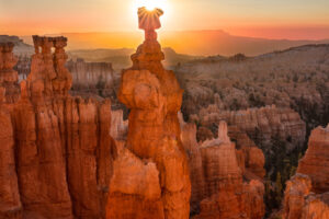 This sandstone structure, known as Thor's Hammer, in Bryce Canyon National Park, is framed by the halo produced by the sun rising behind it.