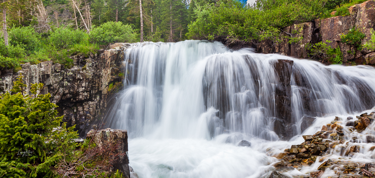 High running stream flow and resulting waterfall coming down from Sneffle's Peak in Ouray, Colorado