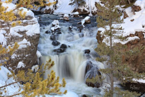 A cold winter's day in Yellowstone National Park finds this waterfall raging through