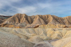 The light from a diffuse sunrise bathes the hills across 20 Mule Team Canyon, creating rich colors and soft contrast.