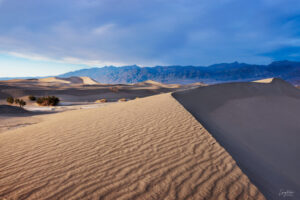 A beautiful sunset sweeping across the face of the Mesquite Sand Dunes in Death Valley National Park.