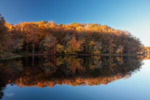 Morning reflections on Fall Creek lake at sunrise