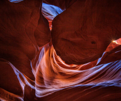 Inside the canyon, light swirls down through the opening above to create a wonderland of color.